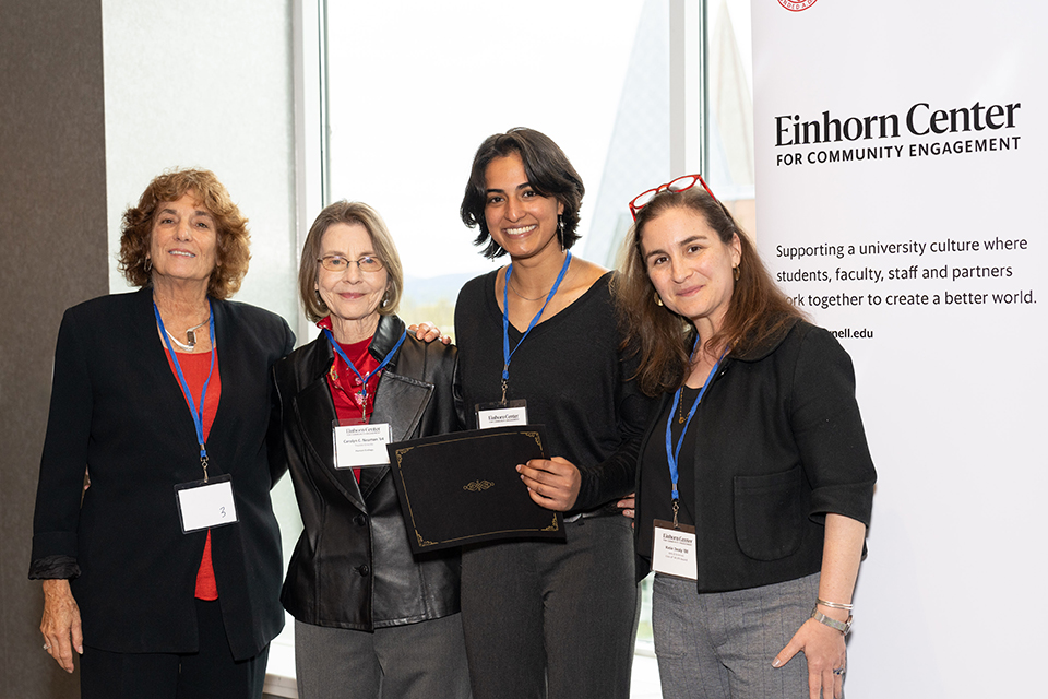 Natalia Urbas '23 (3rd from left) receives the 2023 JFK award from members of the award committee, from left Cynthia Wolloch ’64, Carolyn Neuman '64 and Katie Dealy '00.