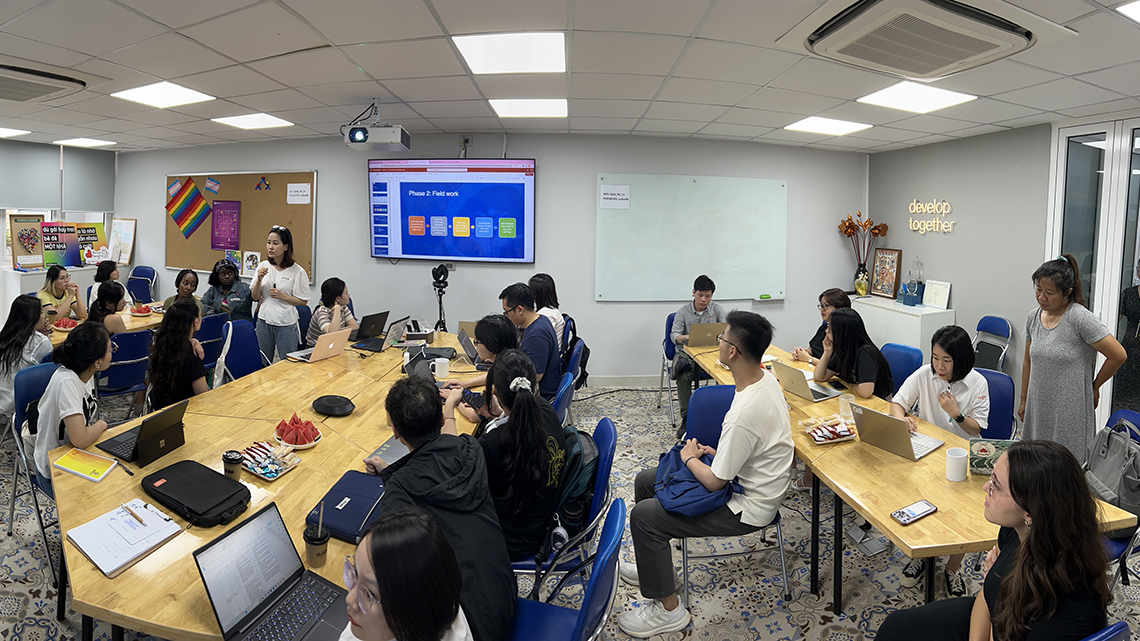 SCDI’s Trang Minh Nguyen, program manager for harm reduction and addiction treatment and children and youth programs, speaks to the team in preparation for work with VACEP storytelling partners in the SCDI offices in Hanoi. Photo by David Koh / VinUni