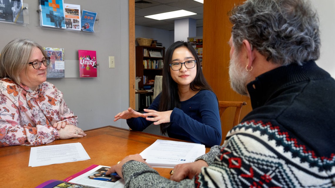 Ying Lin Zhao ’26, center, works with Amy LeViere ’95, left, chief philanthropic services and systems officer, and CEO George Ferrari ’84 at the Tompkins County Community Foundation.