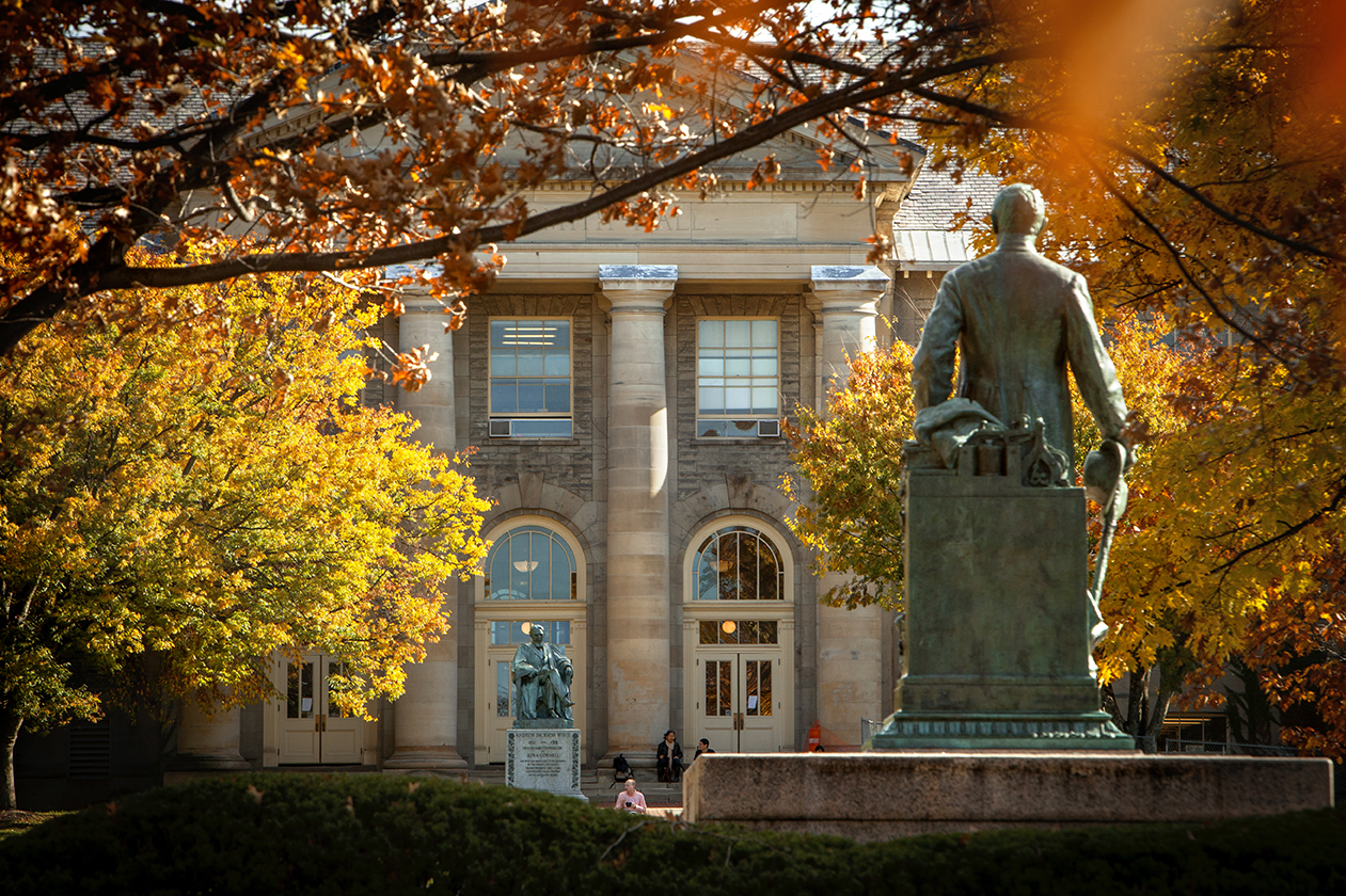 Goldwin Smith Hall and the statue of Ezra Cornell on the Arts Quad in fall.