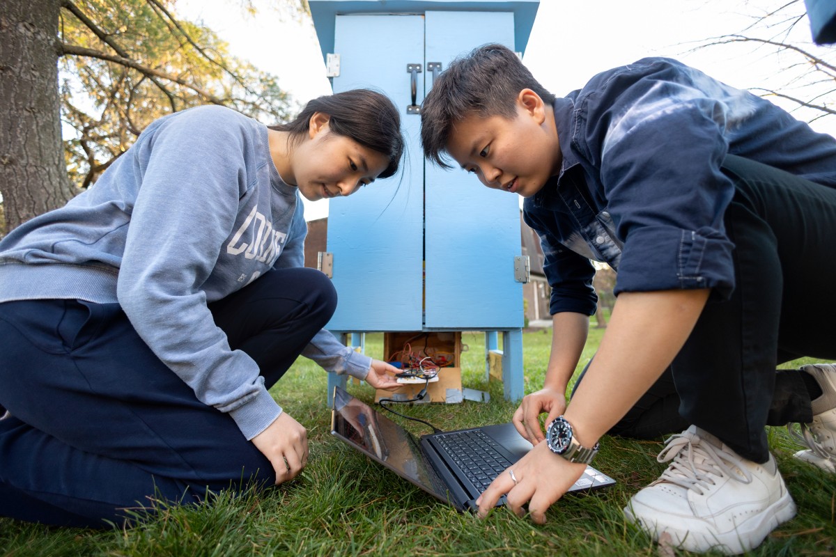 Cornell Engineering students examine a smart food-sharing pantry they designed and built for Mutual Aid Tompkins, equipped with custom wireless technology for real-time monitoring. Cornell University Photography