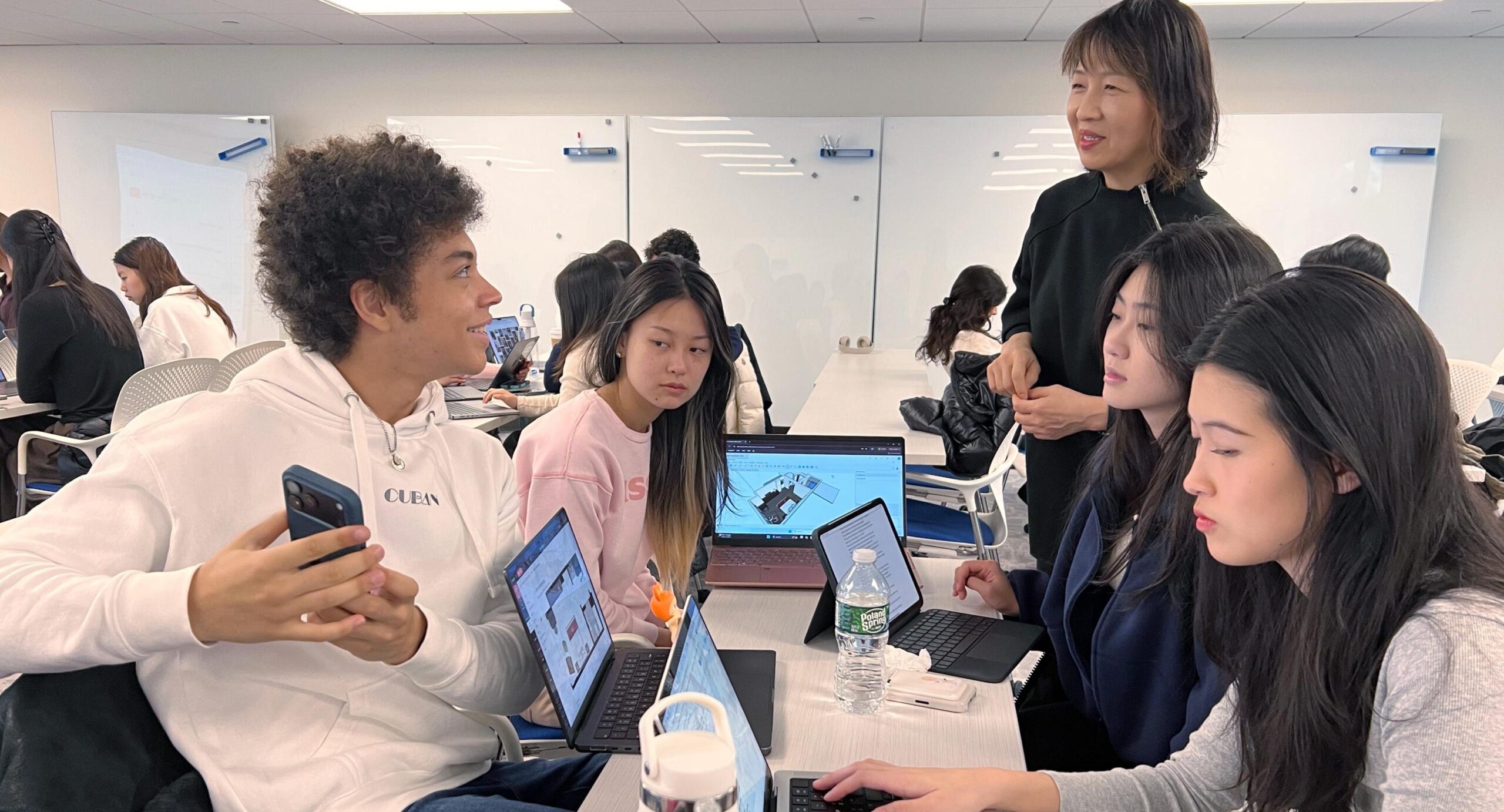 A student team receives design feedback from So-Yeon Yoon, professor of Human Centered Deign in the College of Human Ecology. photo/provided