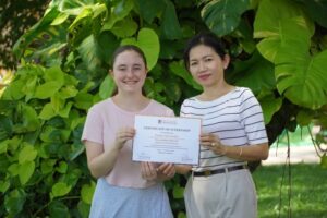 Posed photo of two women holding certificate