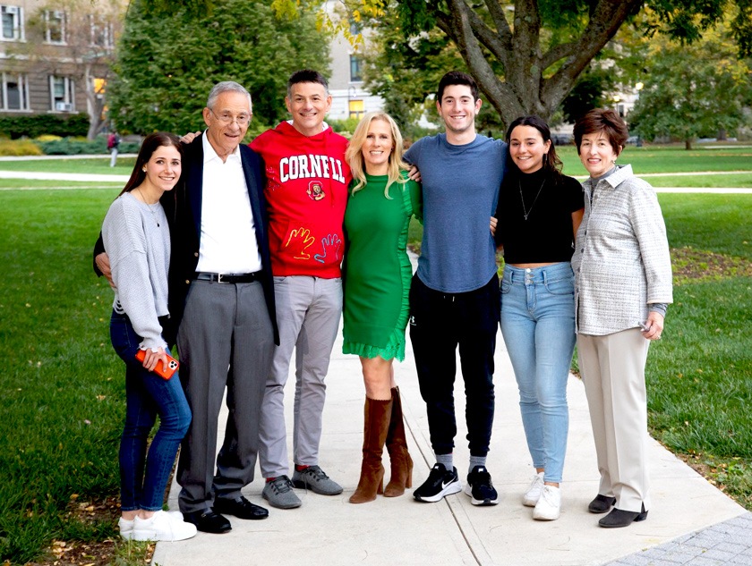 Family portrait of seven people. Left to right, young woman, older man (grandfather), man (father, middle-aged), woman (fiancé, middle aged), young man, young woman, older woman (grandmother)