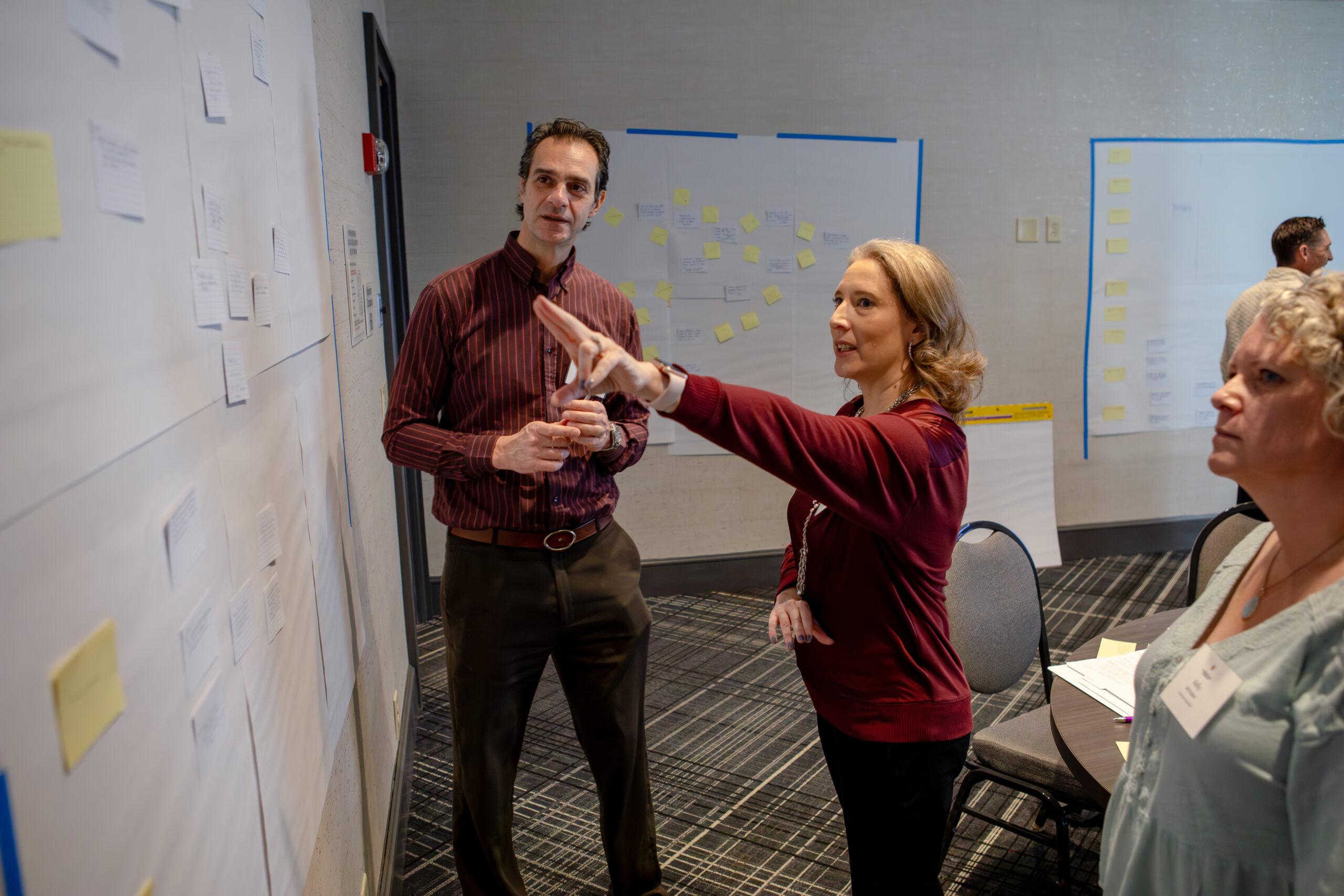Jen Urban (center), Professor of Family Science and Human Development at the College for Community Health at Montclair State University, consults with Basil Safi, Executive Director of the Einhorn Center for Community Engagement at Cornell University, and Kelly Whitaker, Assistant Director of the Engaged College Initiative and Faculty Development at Cornell University  during the 2025 Educating Character Initiative Program Assessment for Character Education (PACE) Workshop in Charlotte, N.C. (Photo by Kate Lord/Educating Character Initiative)